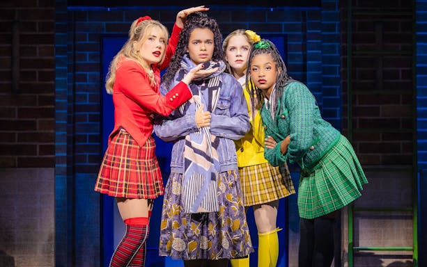 Cast members performing in "Heathers: The Musical" on stage.