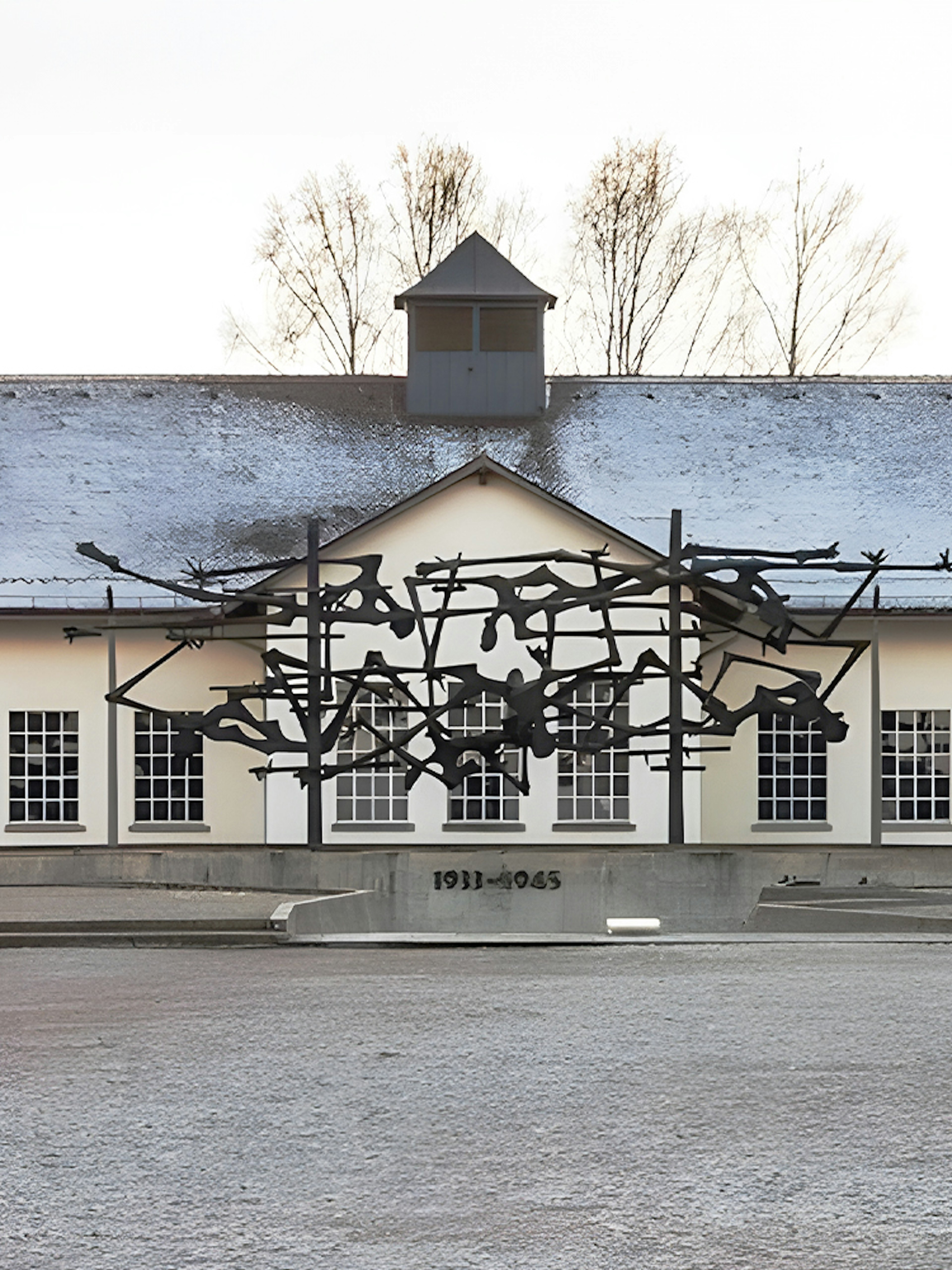 Dachau Concentration Camp Memorial sculpture and building facade.