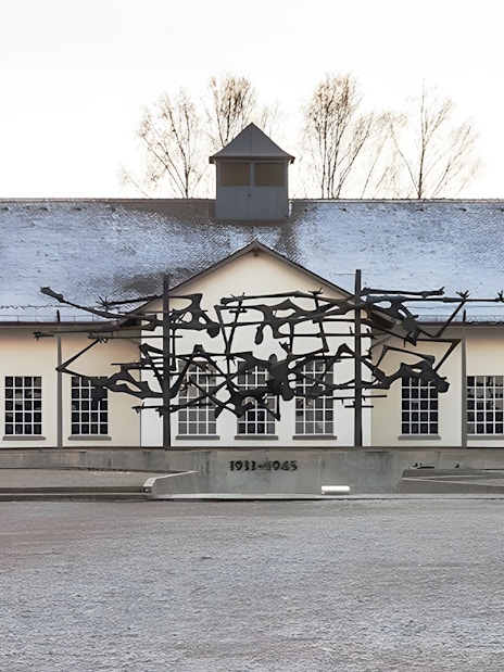 Dachau Concentration Camp Memorial sculpture and building facade.