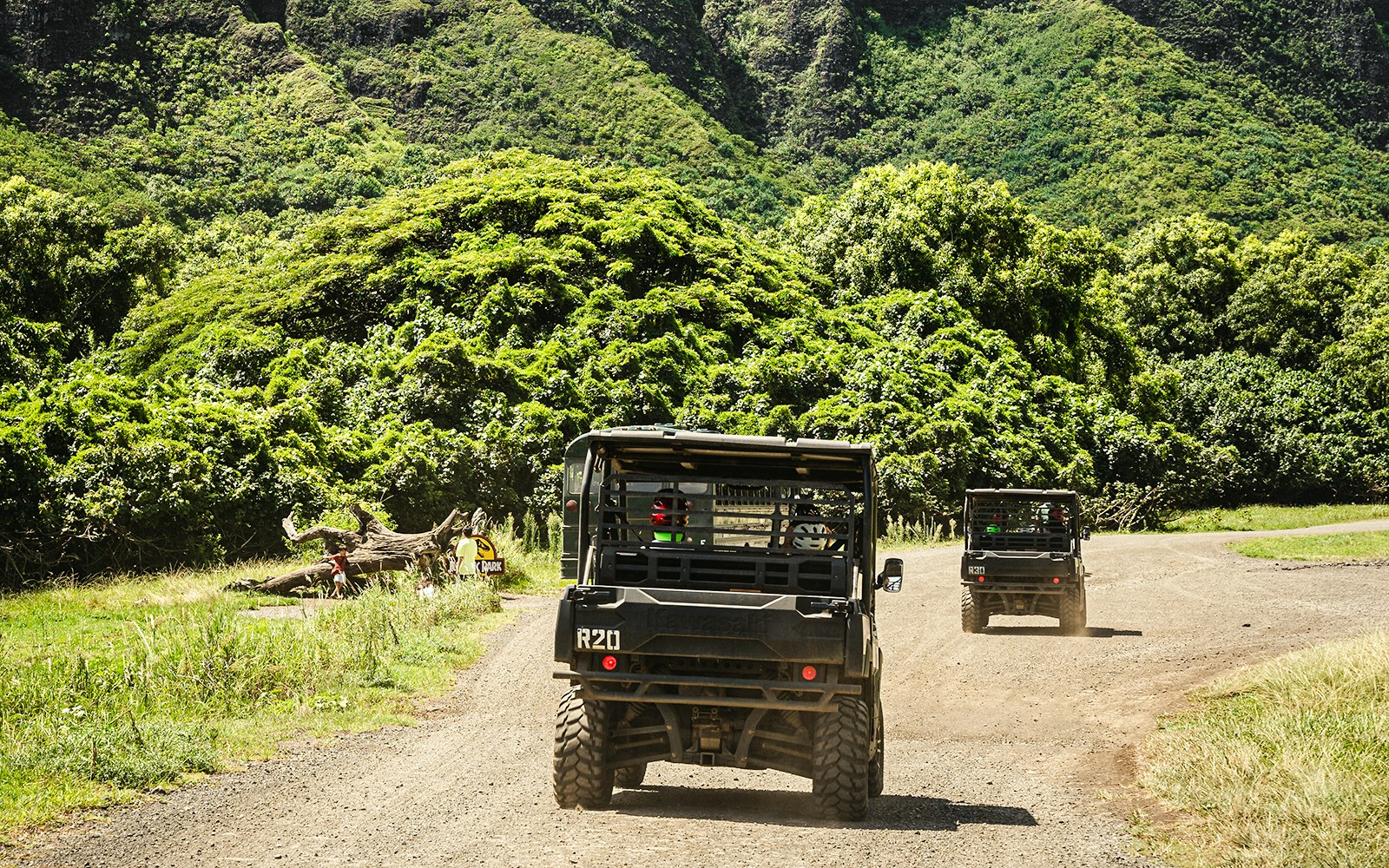 UTVs driving through lush greenery at Kualoa Ranch, Oahu, Hawaii.