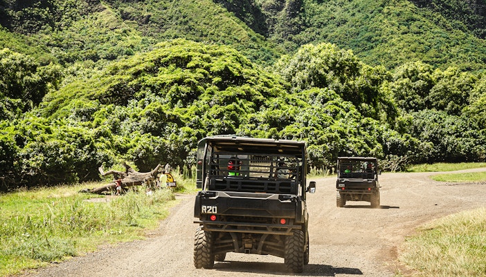 UTVs driving through lush greenery at Kualoa Ranch, Oahu, Hawaii.