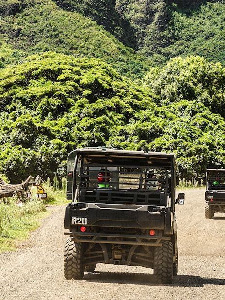 UTVs driving through lush greenery at Kualoa Ranch, Oahu, Hawaii.