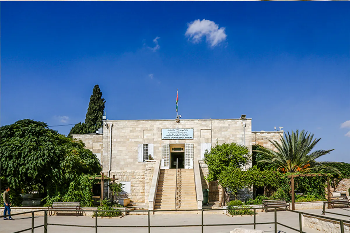Amman Citadel Museum entrance with Jordanian flag, part of Amman City Sightseeing Tour.