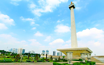 National Monument in Jakarta with city skyline in the background.