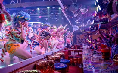 Performers in colorful costumes entertain diners at a Samurai Restaurant Show.