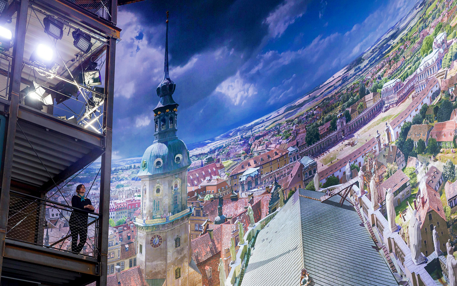 Panometer Dresden interior with panoramic cityscape and visitor on viewing platform.
