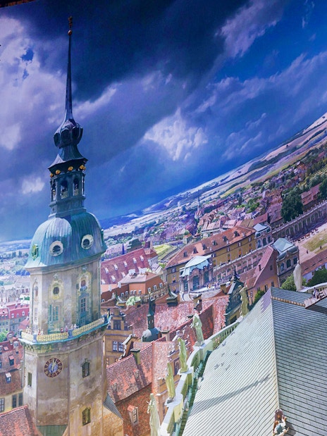 Panometer Dresden interior with panoramic cityscape and visitor on viewing platform.