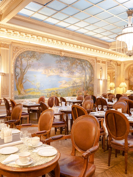 Elegant dining room of Angelina Rivoli with mural, Paris, France.