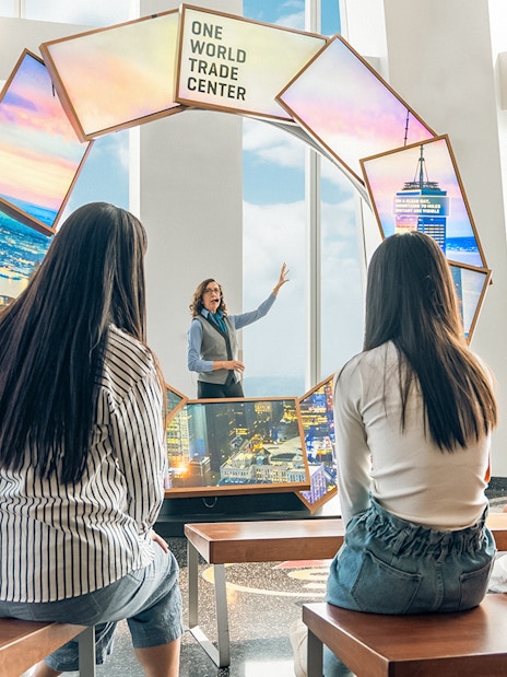 Tourists engaging with City Pulse display at One World Observatory, New York City.