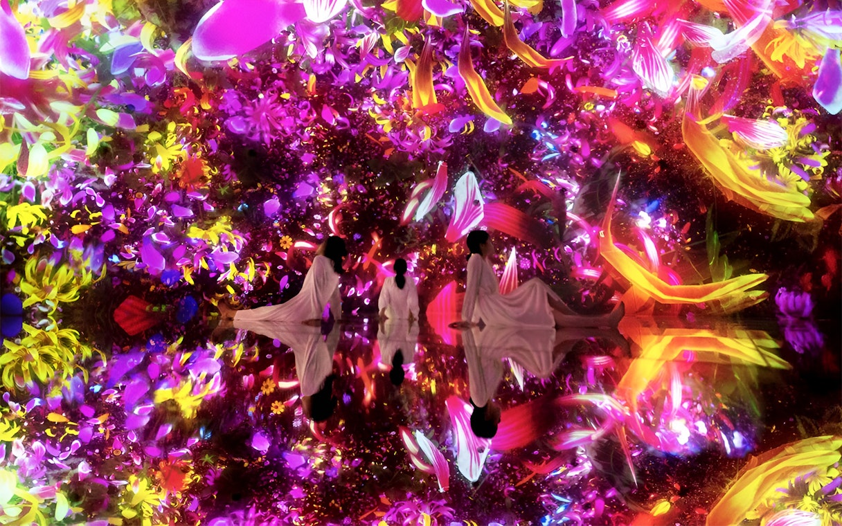 Visitors in immersive digital art installation at TeamLab Planets Tokyo.