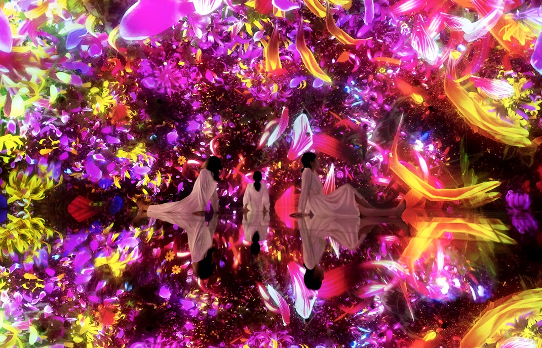 Visitors in immersive digital art installation at TeamLab Planets Tokyo.