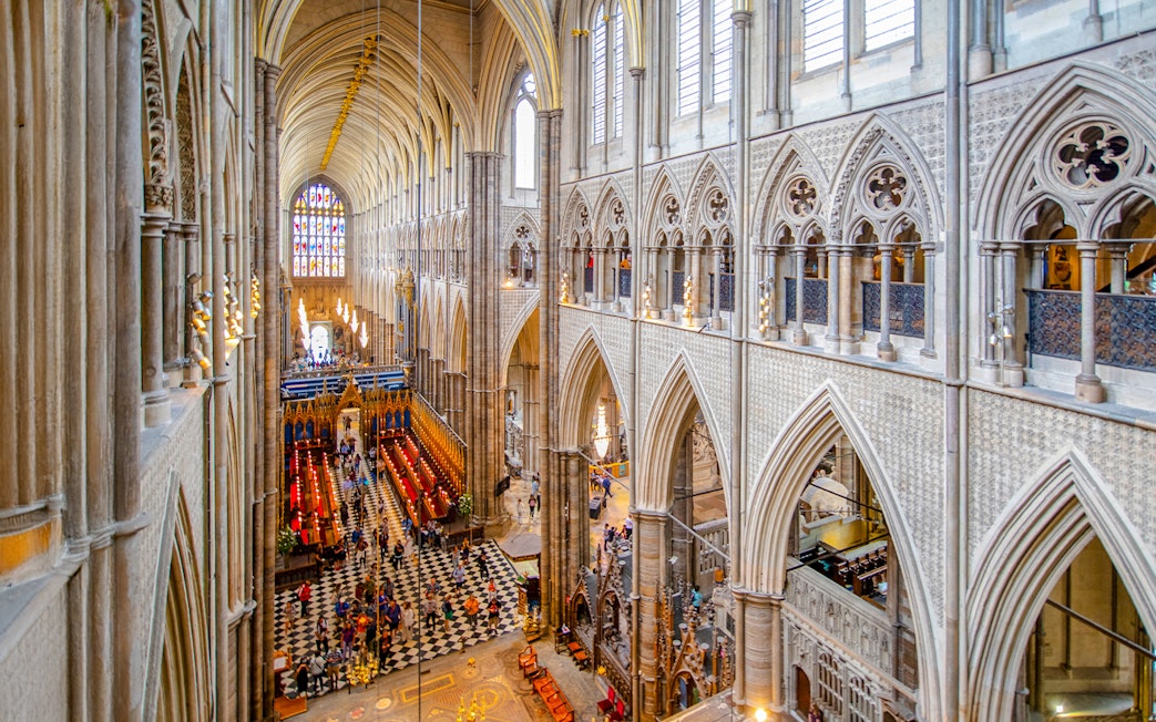 Nave of Westminster Abbey showcasing Gothic architecture and stained glass windows.