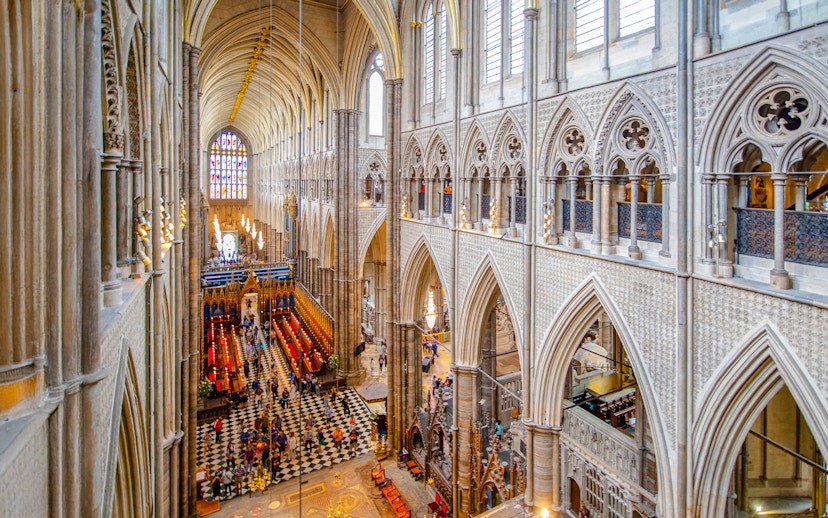 Nave of Westminster Abbey showcasing Gothic architecture and stained glass windows.