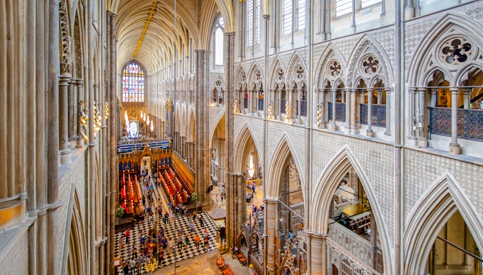 Nave of Westminster Abbey showcasing Gothic architecture and stained glass windows.