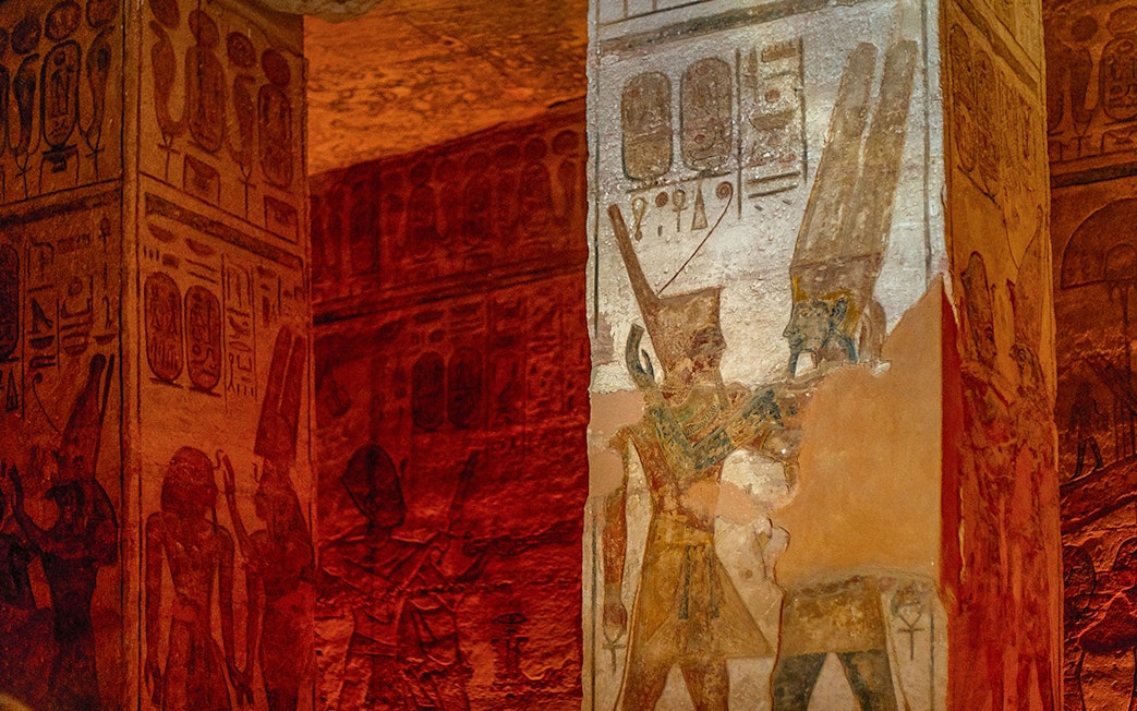 Abu Simbel Temple interior with ancient Egyptian hieroglyphs and carvings on stone walls.