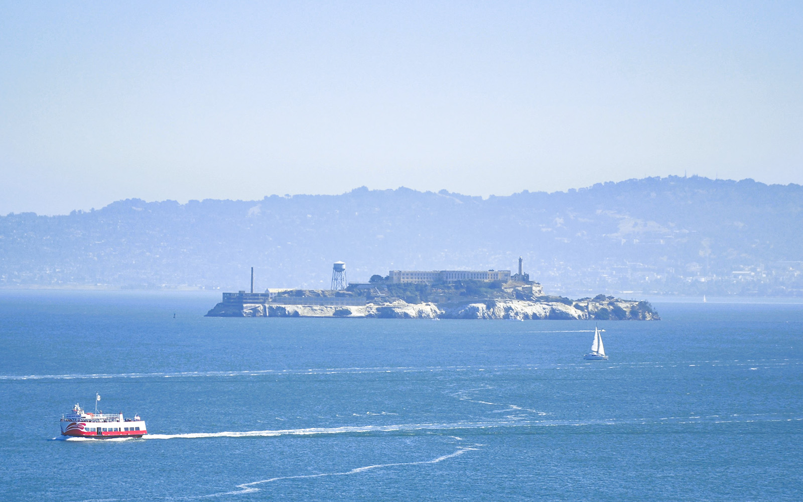 Cruise boat near Alcatraz Island on Golden Gate Bridge tour, San Francisco Bay.