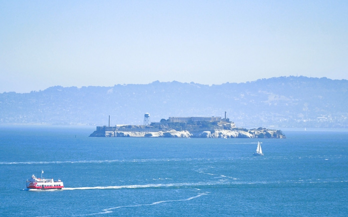 Cruise boat near Alcatraz Island on Golden Gate Bridge tour, San Francisco Bay.