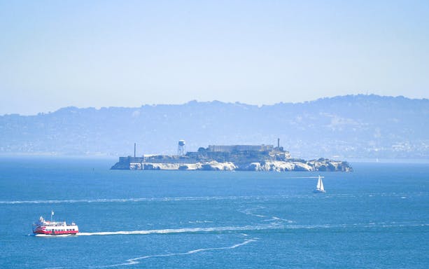 Cruise boat near Alcatraz Island on Golden Gate Bridge tour, San Francisco Bay.