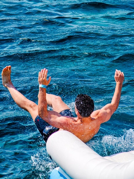 Guest sliding into the sea during Blue Lagoon and 3 Island tour from Split.