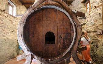 Large wooden water barrel inside Monastery of Varlaam, Meteora.