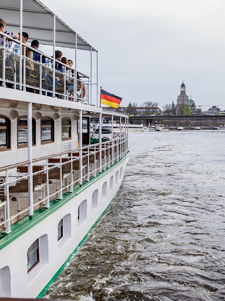 Cruise ship on Elbe River with Dresden skyline in background.