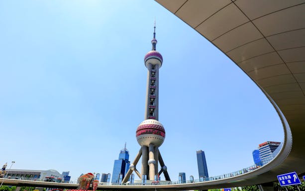 Oriental Pearl TV Tower in Shanghai, China with city skyline in the background.