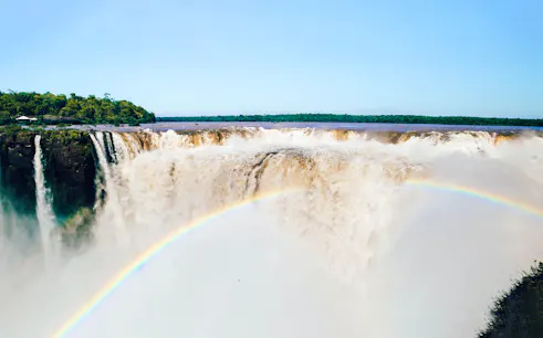 Sunrise view of Iguazu Falls with rainbow, Foz do Iguaçu, early park access tour.