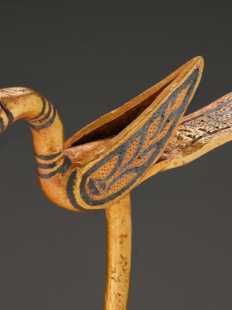 Viking Age bird-shaped pin with intricate carvings and gemstone eyes.