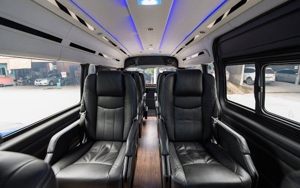 Private transfer van interior with leather car seats for airport to Bangkok route.