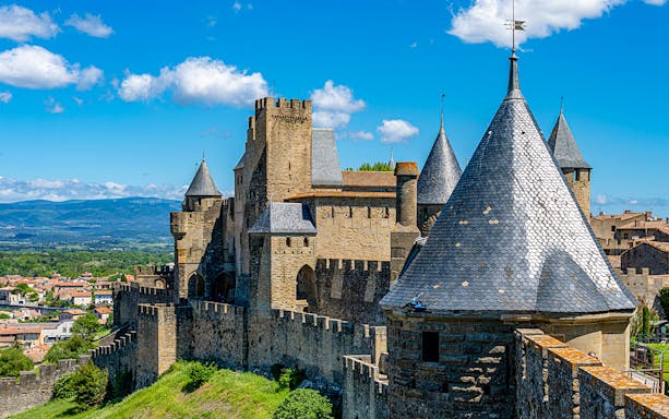 Carcassonne Castle's Tour de la Justice with medieval towers and city view.