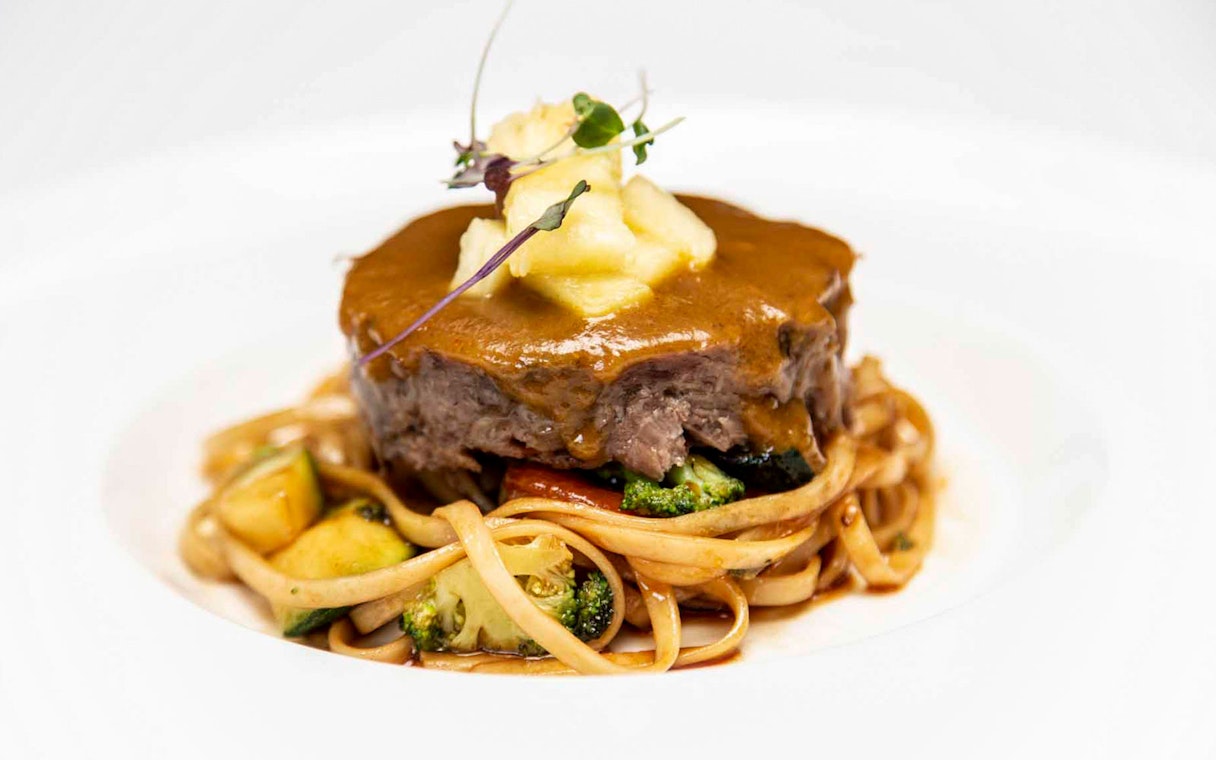 La carte dinner with beef and pasta at Tablao El Arenal.