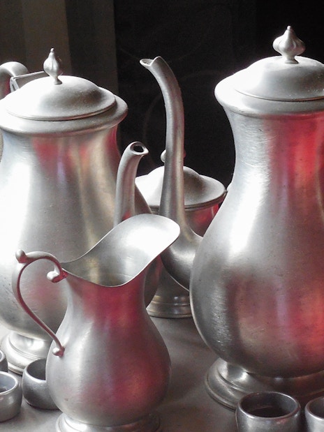 Silver tea set on a red tablecloth, part of a cultural experience on the Batu Caves tour from Kuala Lumpur.