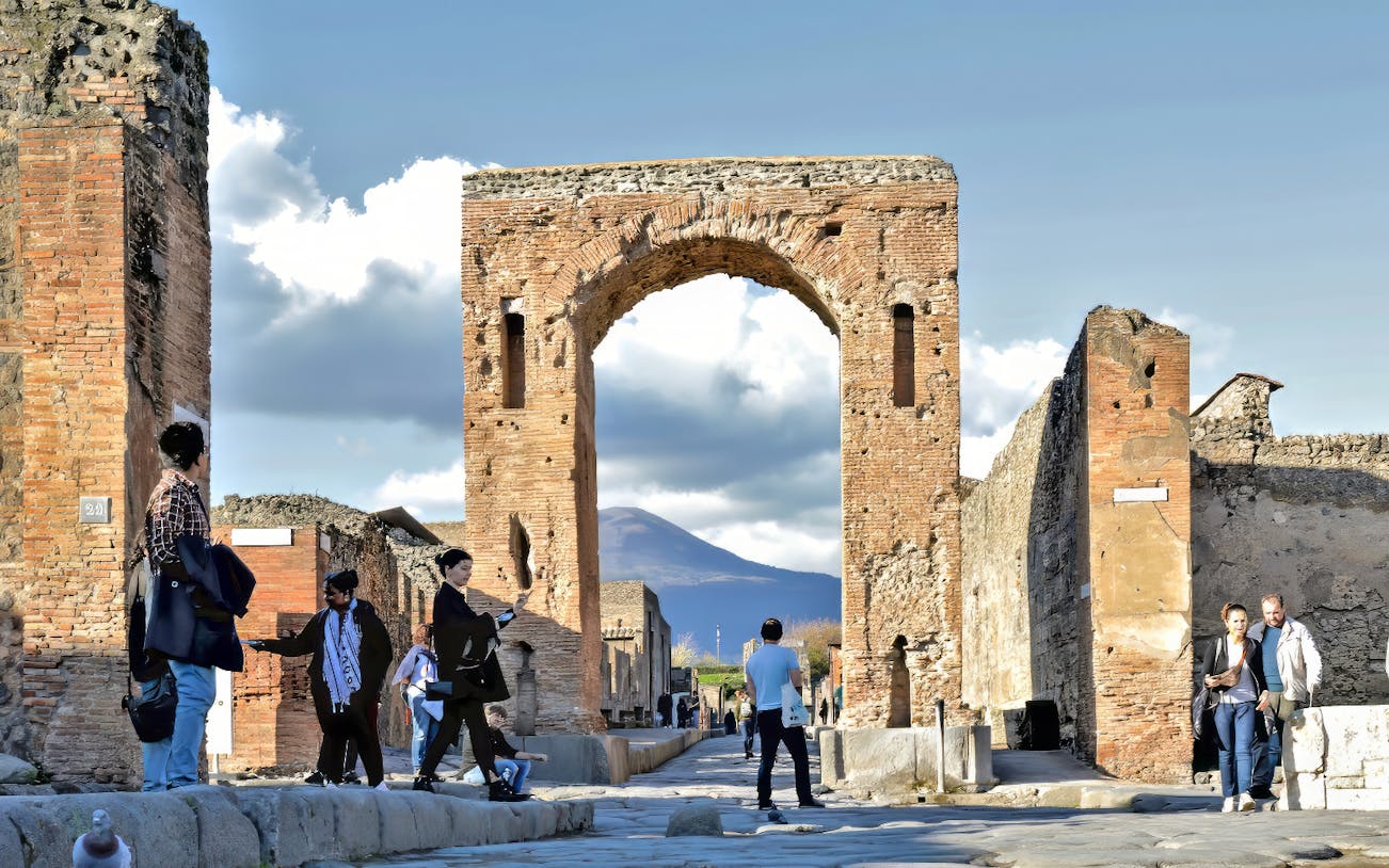 People exploring Pompeii ruins