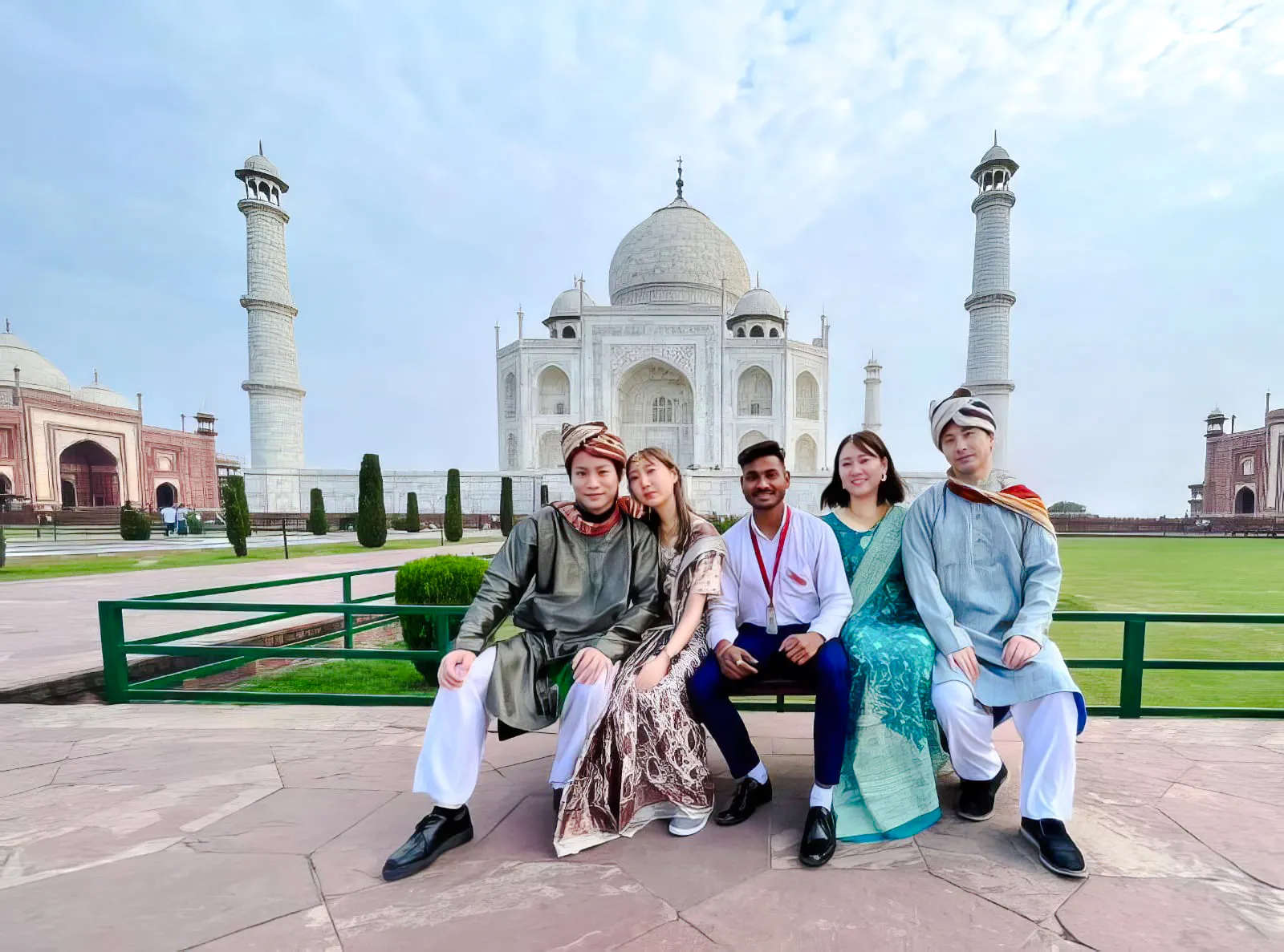 Group of tourists in front of the Taj Mahal, Agra, during a tour from Delhi.