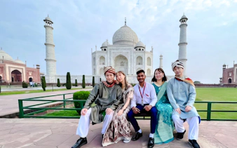 Group of tourists in front of the Taj Mahal, Agra, during a tour from Delhi.