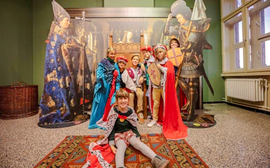 Guests in medieval costumes at Historium Bruges exhibit.