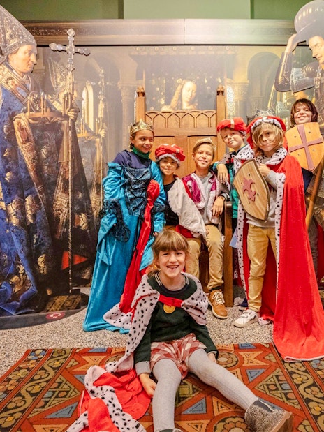 Guests in medieval costumes at Historium Bruges exhibit.