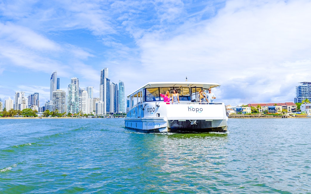 Gold Coast HOHO sightseeing cruise with city skyline in background.