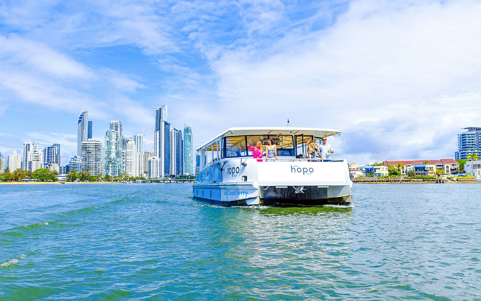 Gold Coast HOHO sightseeing cruise with city skyline in background.