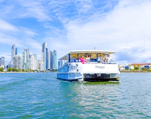 Gold Coast HOHO sightseeing cruise with city skyline in background.