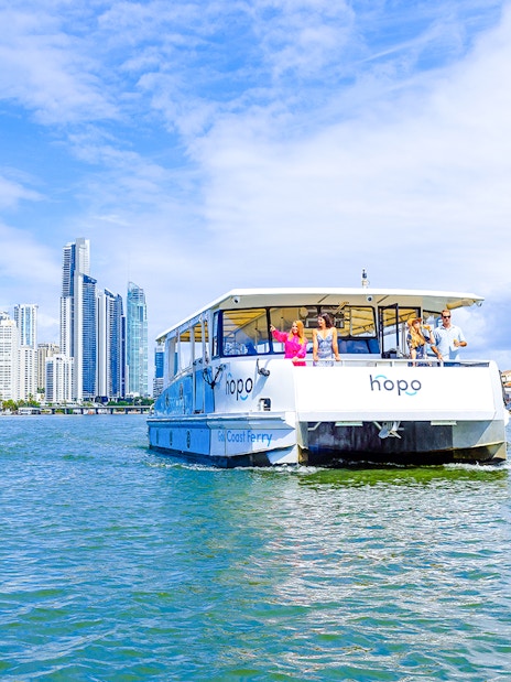 Gold Coast HOHO sightseeing cruise with city skyline in background.