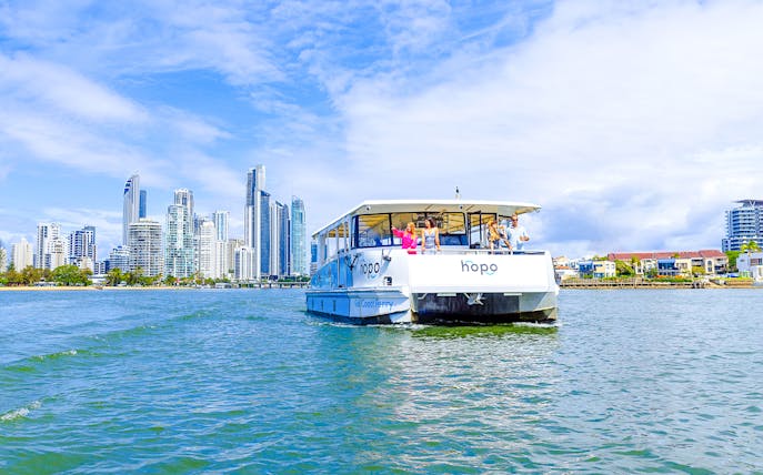 Gold Coast HOHO sightseeing cruise with city skyline in background.