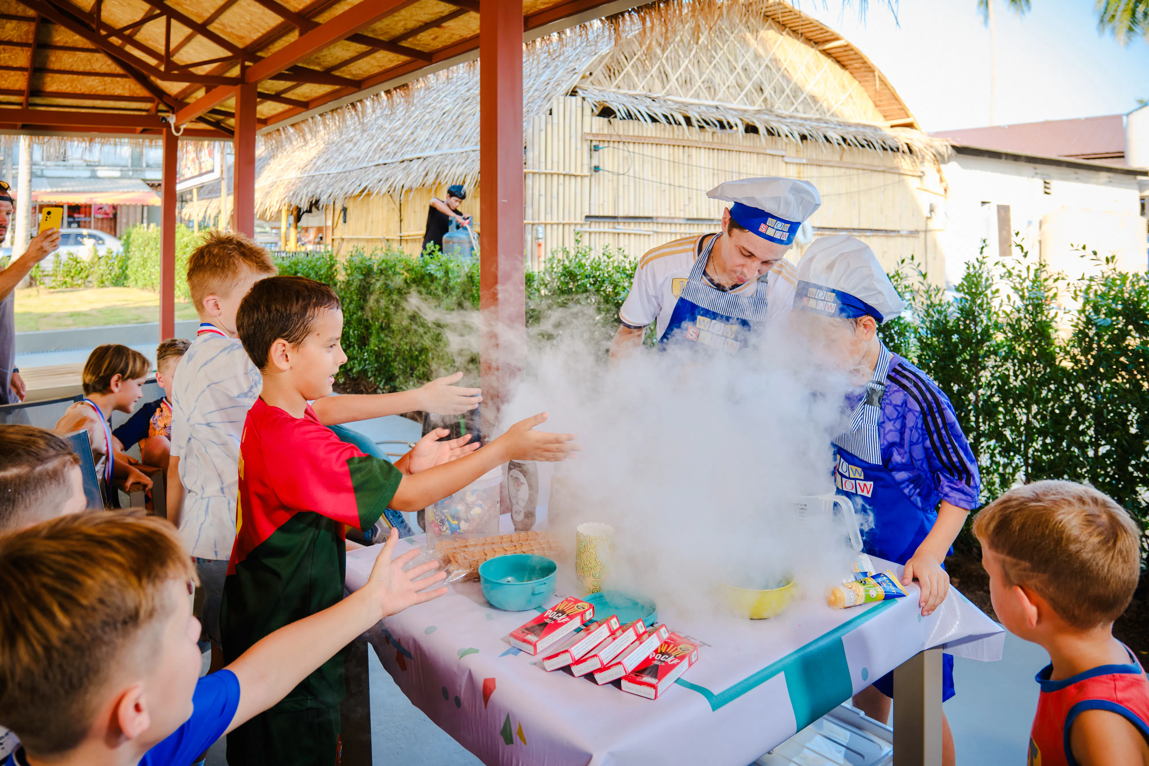 Children enjoying a cooking activity with chefs at a birthday party in Phuket.