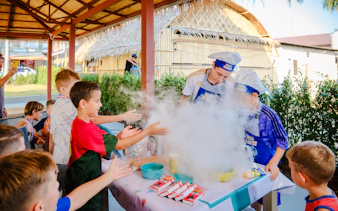 Children enjoying a cooking activity with chefs at a birthday party in Phuket.