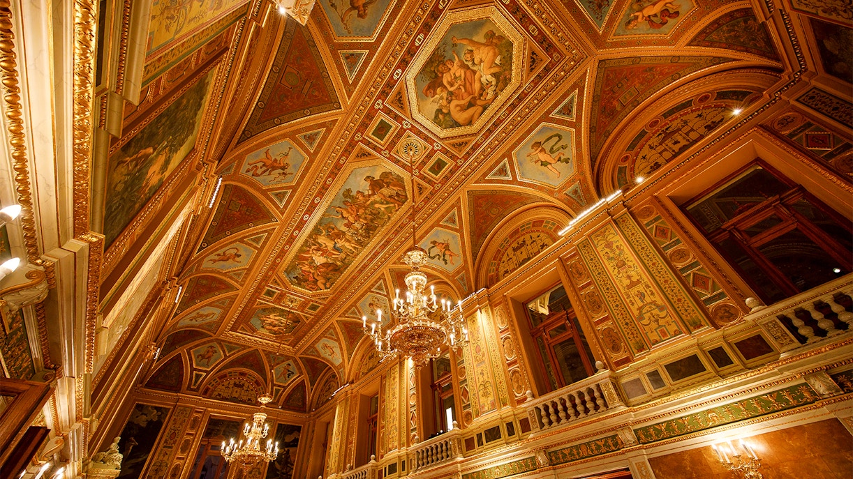 Wide angle view of ornate ceiling and chandeliers in the Hungarian State Opera, Budapest.