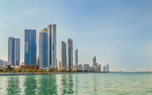 Dubai skyline with modern skyscrapers along the waterfront, viewed from the sea.