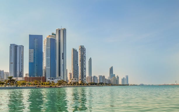 Dubai skyline with modern skyscrapers along the waterfront, viewed from the sea.