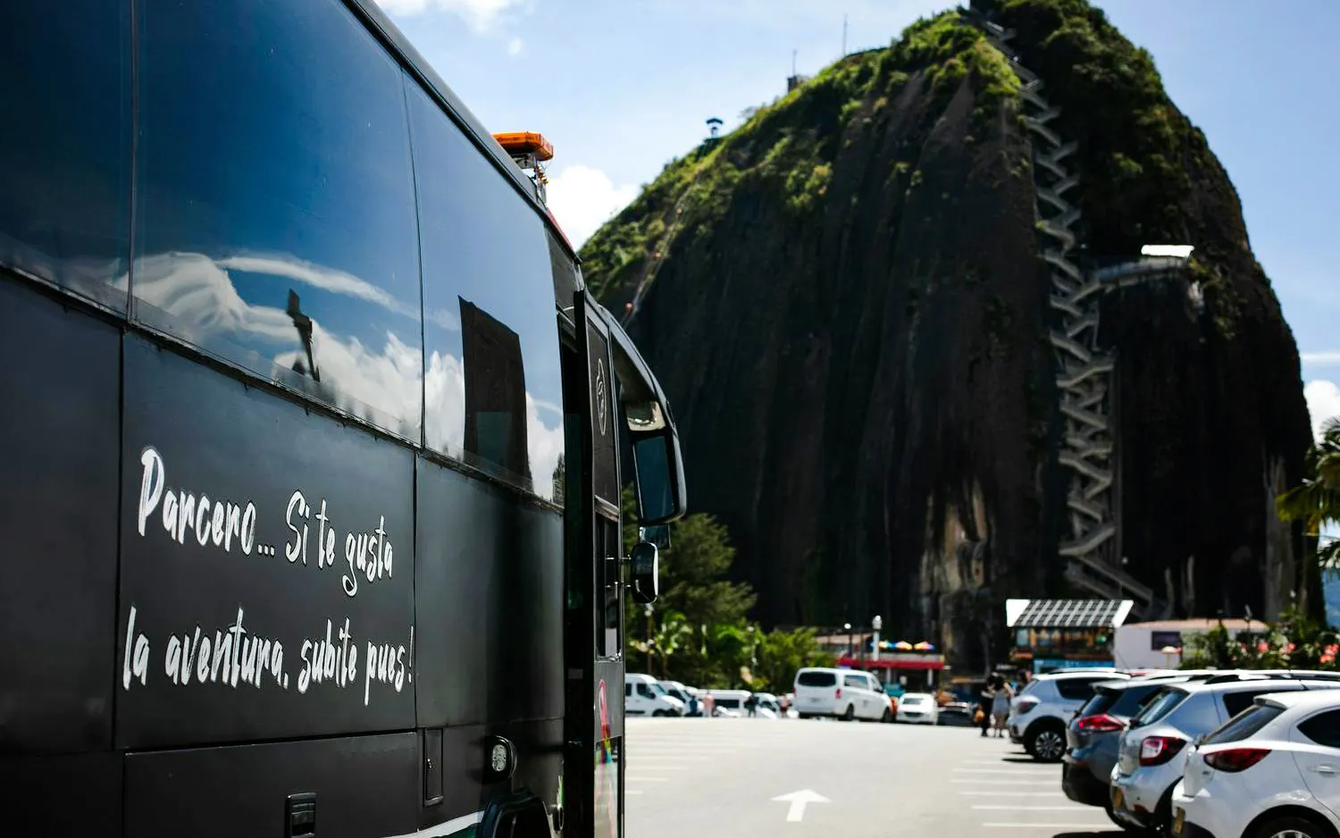 Tour bus near El Peñón de Guatapé rock in Antioquia, Colombia.