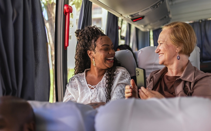 Customers smiling on air-conditioned bus during Herculaneum tour from Naples.