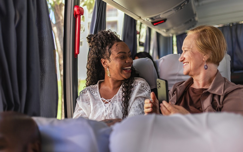 Customers smiling on air-conditioned bus during Herculaneum tour from Naples.